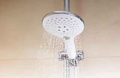 a shower head with water coming out of it at NH Centre Utrecht Hotel in Utrecht