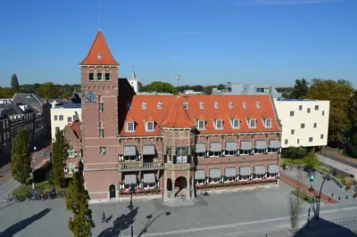 an aerial view of a large brick building with a tower at Hotel Theater Figi in Zeist