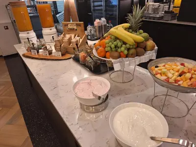 a counter with a bunch of fruits and vegetables on it at Hotel Theater Figi in Zeist