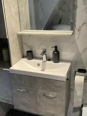 a bathroom sink with a soap dispenser on it at Casa di maksch de miniatura in Amsterdam