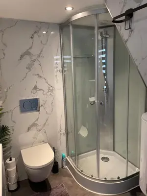 a bathroom with a shower and a toilet at Casa di maksch de miniatura in Amsterdam