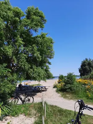 a group of picnic tables next to a beach at Studio Flevo Batavia in Lelystad