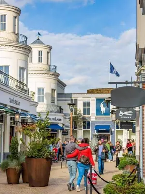 a group of people walking down a street with buildings at Studio Flevo Batavia in Lelystad