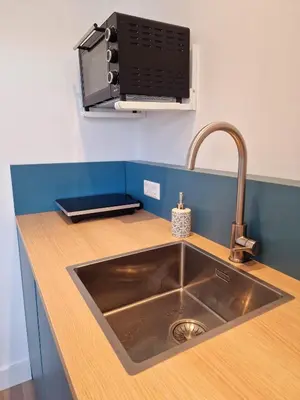 a kitchen counter with a sink and a microwave at Studio Flevo Batavia in Lelystad