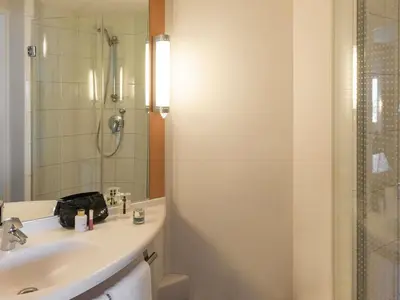 a bathroom with a sink and a shower at ibis Amsterdam Centre in Amsterdam