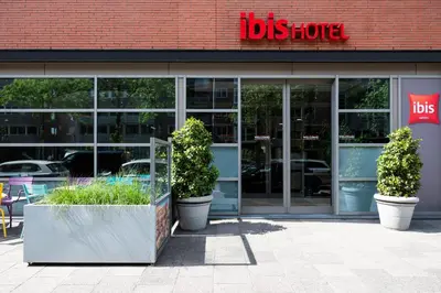 a store front with two potted plants in front of it at ibis Amsterdam Centre Stopera in Amsterdam