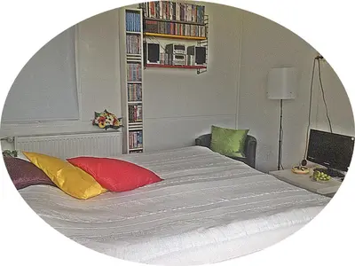 a bedroom with a large bed and a mirror at B&B 2 Hoog Lelystad in Lelystad