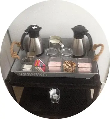 a small black table with two pitchers and tea pots at B&B 2 Hoog Lelystad in Lelystad