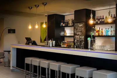 a bar with a purple counter and stools at Holiday Inn Express Amsterdam Arena Towers by IHG in Amsterdam
