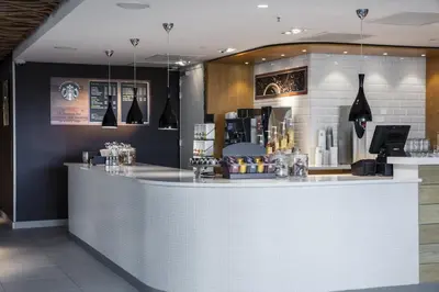 a bar in a restaurant with a counter at Holiday Inn Express Amsterdam Arena Towers by IHG in Amsterdam
