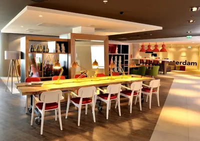 a dining room with a long table and chairs at Holiday Inn Express Amsterdam Arena Towers by IHG in Amsterdam