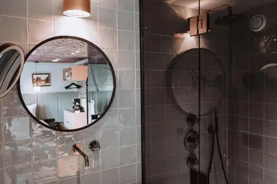 a bathroom with a mirror and a shower at The Highlander Amsterdam in Amsterdam