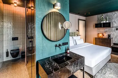a hotel room with a bed and a mirror at The Highlander Amsterdam in Amsterdam