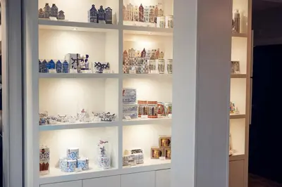 a display cabinet filled with blue and white vases at Singel Hotel Amsterdam in Amsterdam