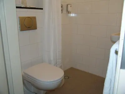 a bathroom with a toilet and a sink at Singel Hotel Amsterdam in Amsterdam