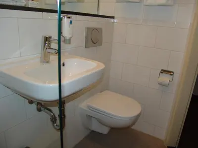 a bathroom with a sink and a toilet at Singel Hotel Amsterdam in Amsterdam