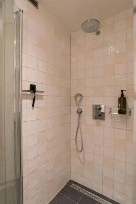 a shower with a shower head in a bathroom at Studio in creative district, FREE parking in Amsterdam