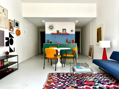 a living room with a couch and a table and chairs at Studio in creative district, FREE parking in Amsterdam