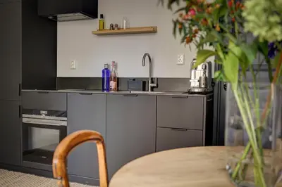 a kitchen with a sink and a table at Canal House with Garden in Amsterdam