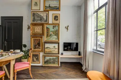 a room with a bunch of pictures on the wall at Canal House with Garden in Amsterdam