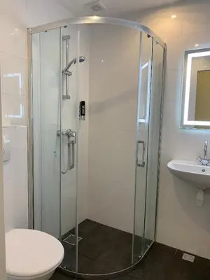 a bathroom with a shower and a toilet and a sink at Orange Tulip Hotel in Amsterdam