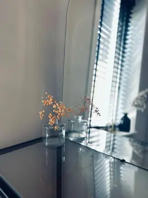 two vases with flowers in them sitting on a table at The Bank's Lodge by ZILT in Limmen