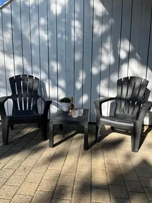 two chairs and a table on a balcony at Studio J. in Egmond aan Zee