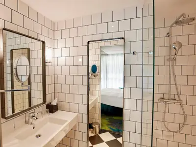 a bathroom with a tub and a sink and a shower at Carlton President in Utrecht