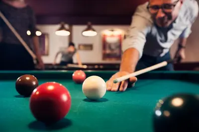 a man playing billiard with a cue on a pool table at Carlton President in Utrecht