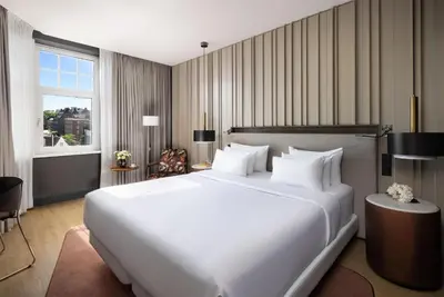 a large white bed in a hotel room at NH Collection Amsterdam Flower Market in Amsterdam