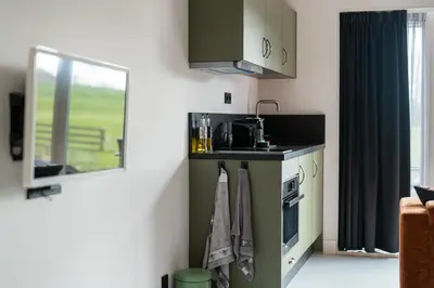 a small kitchen with a stove and a window at Huize Leeghwater in Zuidoostbeemster