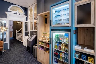 a room with a refrigerator filled with lots of drinks at Hotel Nes Amsterdam in Amsterdam