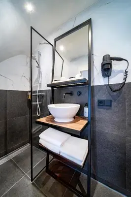 a bathroom with a sink and a shower at Hotel Nes Amsterdam in Amsterdam