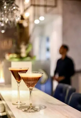 two martini glasses sitting on a bar at Boutique Hotel Albus Amsterdam Centre in Amsterdam