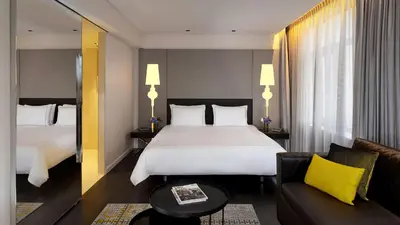 a hotel room with a large bed and a couch at Park Plaza Victoria Amsterdam in Amsterdam
