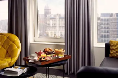 a tray of food on a table in a room with a window at Park Plaza Victoria Amsterdam in Amsterdam