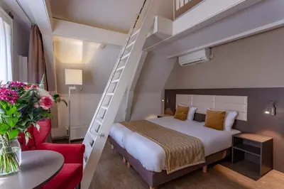 a bedroom with a bed and a ladder at Avenue Hotel in Amsterdam