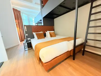 a bedroom with a bed with a ladder in it at Avenue Hotel in Amsterdam