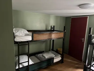 a room with two bunk beds and a sink at Amsterdam Hostel Uptown in Amsterdam