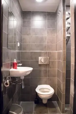a bathroom with a toilet and a sink at Amsterdam Hostel Uptown in Amsterdam
