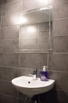 a bathroom with a sink and a mirror at Amsterdam Hostel Uptown in Amsterdam