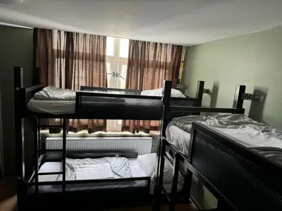 two bunk beds in a room with a window at Amsterdam Hostel Uptown in Amsterdam