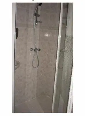 a shower with a glass door in a bathroom at Hotel de Westertoren in Amsterdam