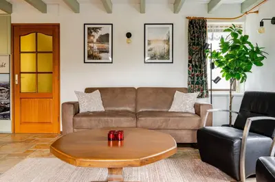 a living room with a couch and a coffee table at Huisje Marie Loosdrecht in Loosdrecht
