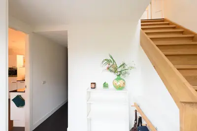 a staircase in a house with a vase on a counter at Spacious and attractive family home near Amsterdam in Overveen