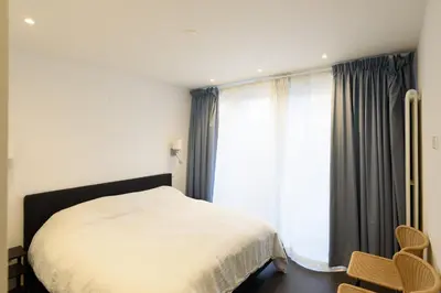 a bedroom with a bed and a large window at Spacious and attractive family home near Amsterdam in Overveen