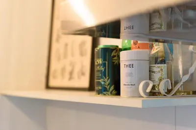 a shelf with books and coffee cups on it at Spacious and attractive family home near Amsterdam in Overveen