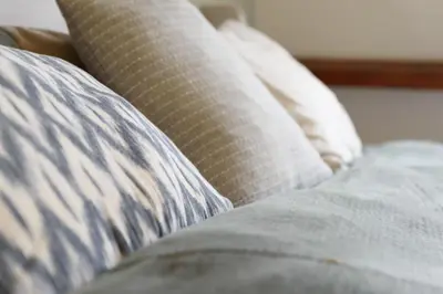 a close up of a bed with two pillows at Spacious and attractive family home near Amsterdam in Overveen