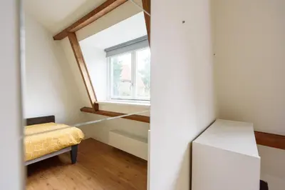 a small room with a window and a bed at Spacious and attractive family home near Amsterdam in Overveen