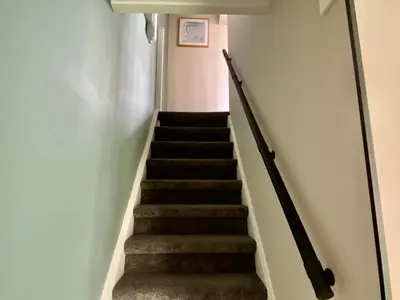 a flight of stairs in a house at Glücklich am Meer Apartment Deluxe mit Wellnesszugang in Egmond aan Zee